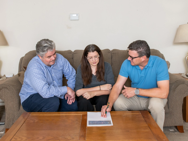 client and seller discussion of paperwork for house selling